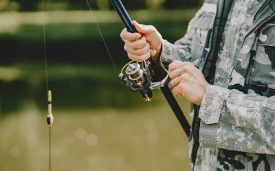 man-fishing-holds-angling-rod